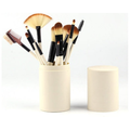Ivory makeup brush set shown upright in a matching cylindrical case