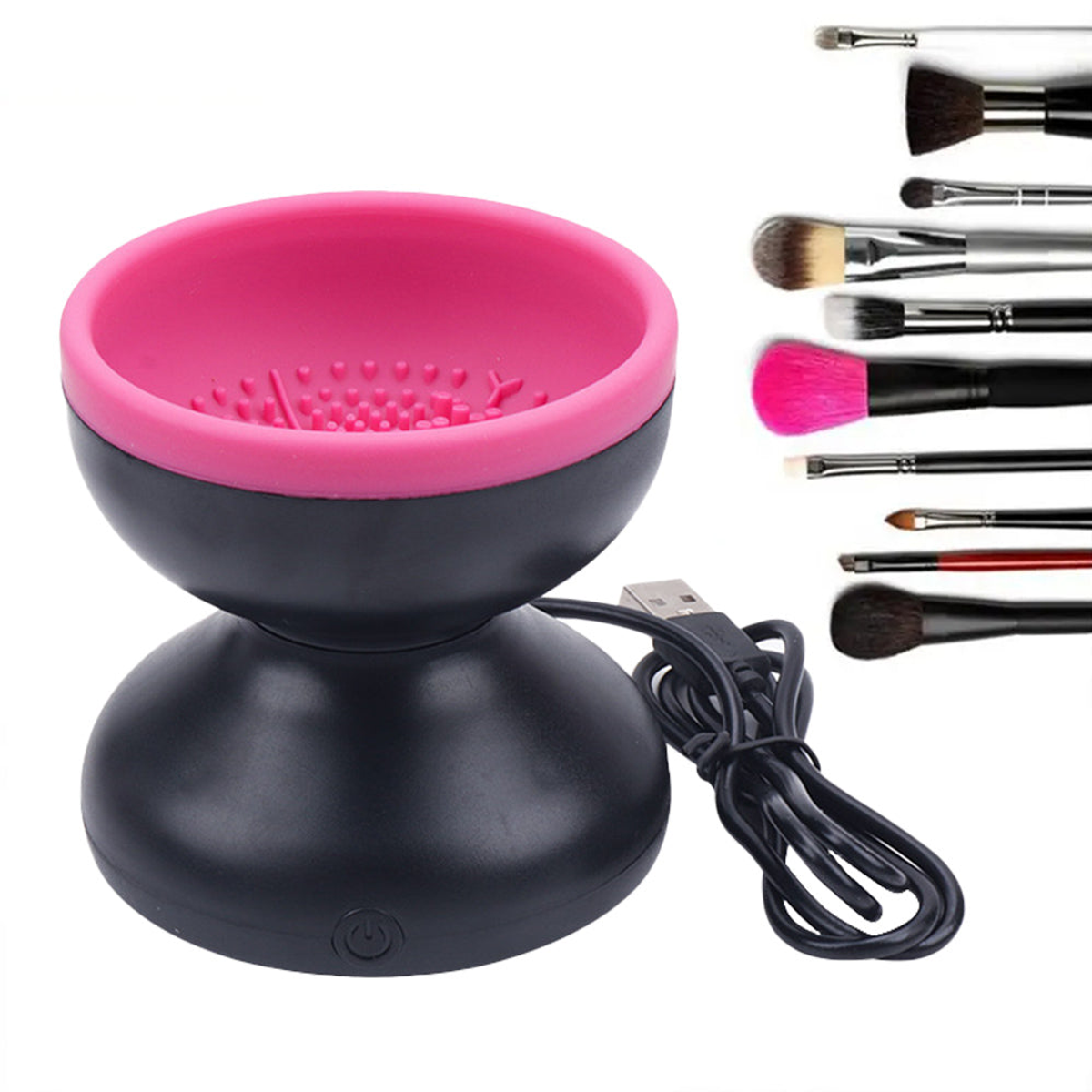 Black and pink electric makeup brush cleaner with USB cable beside assorted brushes