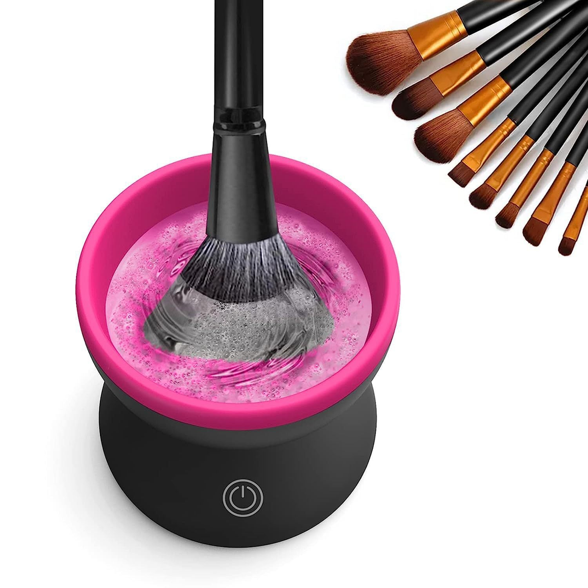 Black and pink electric brush cleaner agitating a makeup brush in water